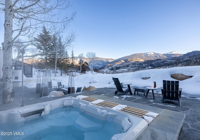 snow covered pool with a mountain view