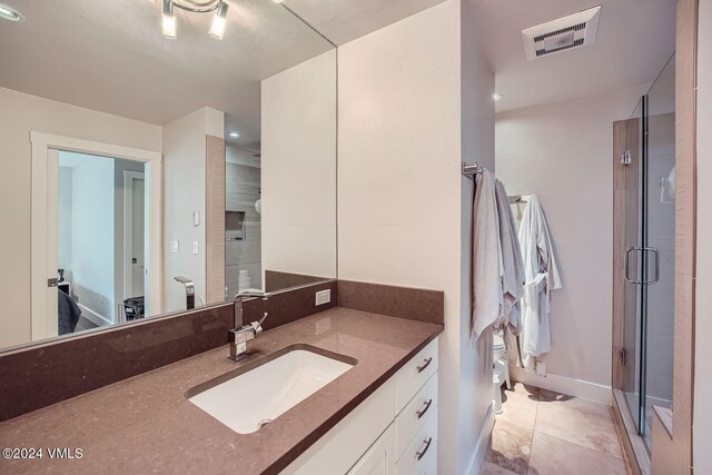 bathroom featuring vanity, toilet, and an enclosed shower