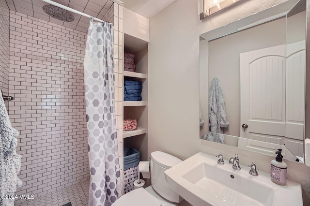 bathroom featuring walk in shower, toilet, and sink