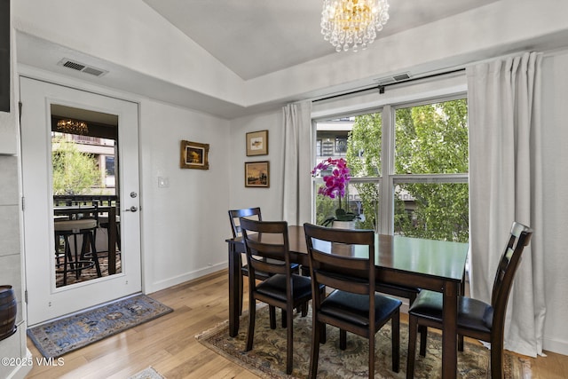 55 River Pines Ct Unit A302, Edwards, CO 81632 - dining area featuring a chandelier, wood finished floors, lofted ceiling, healthy amount of natural light, and baseboards