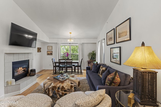 55 River Pines Ct Unit A302, Edwards, CO 81632 - living room featuring vaulted ceiling, wood finished floors, a fireplace, and baseboards