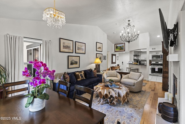 55 River Pines Ct Unit A302, Edwards, CO 81632 - living room featuring a chandelier, light wood-style flooring, and vaulted ceiling