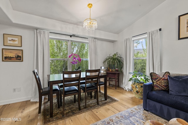 55 River Pines Ct Unit A302, Edwards, CO 81632 - dining room featuring lofted ceiling, healthy amount of natural light, a chandelier, light wood-style floors, and baseboards