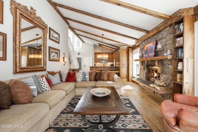 living room with vaulted ceiling with beams, a fireplace, and light wood-type flooring