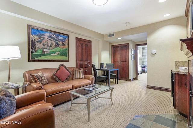 living area featuring baseboards, recessed lighting, visible vents, and light colored carpet