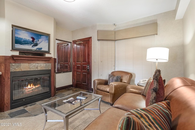 living area with a tile fireplace