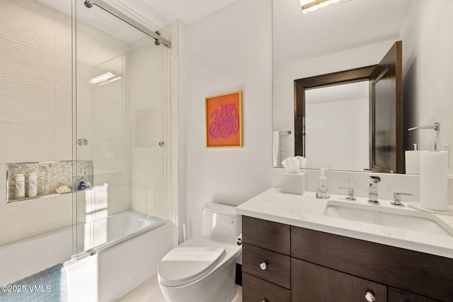 full bath featuring vanity, toilet, and bath / shower combo with glass door