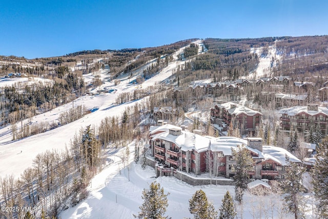 snowy aerial view featuring a mountain view