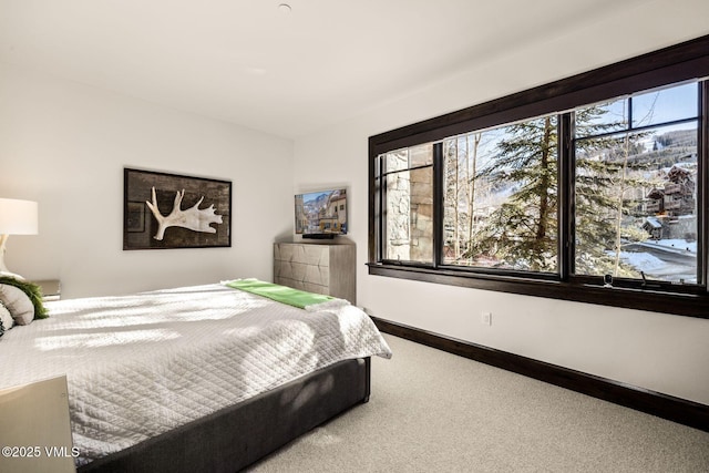 carpeted bedroom featuring baseboards