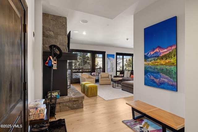 interior space featuring recessed lighting, wood finished floors, and a fireplace