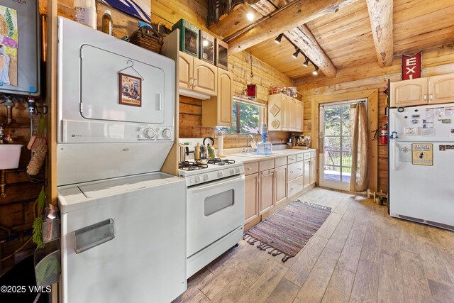 245 Main St, Eagle, CO 81631 - kitchen with white appliances, stacked washer / dryer, a wood ceiling with exposed beams, light brown cabinets, and light countertops