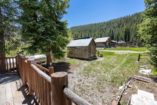 245 Main St, Eagle, CO 81631 - view of yard featuring a wooded view and a storage unit