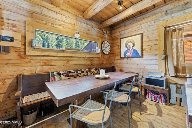 245 Main St, Eagle, CO 81631 - dining area featuring a wood ceiling with exposed beams, wood walls, and hardwood / wood-style floors