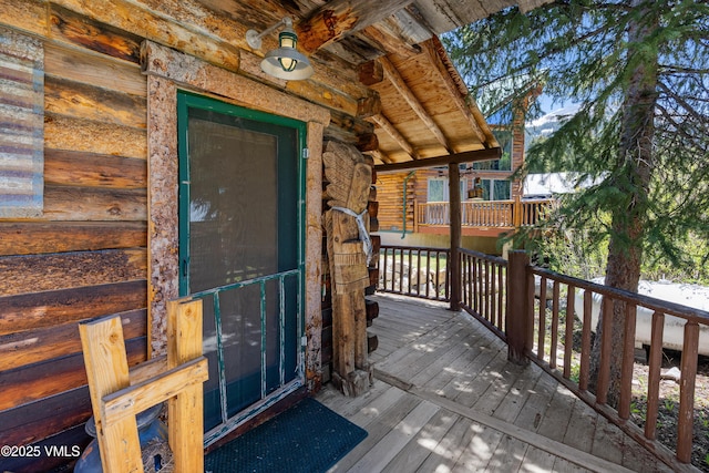 245 Main St, Eagle, CO 81631 - entrance to property with a wooden deck and log exterior