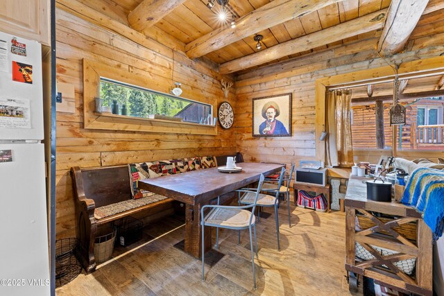 245 Main St, Eagle, CO 81631 - dining space with a wooden ceiling with exposed beams, light wood-type flooring, and wooden walls