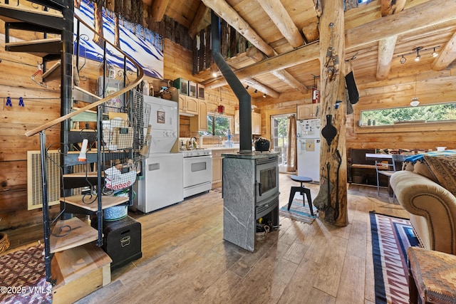 245 Main St, Eagle, CO 81631 - living area with a wood stove, wooden ceiling, light wood-style floors, wood walls, and track lighting