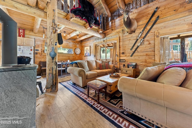 245 Main St, Eagle, CO 81631 - living area featuring plenty of natural light, a wooden ceiling with exposed beams, hardwood / wood-style floors, and wood walls