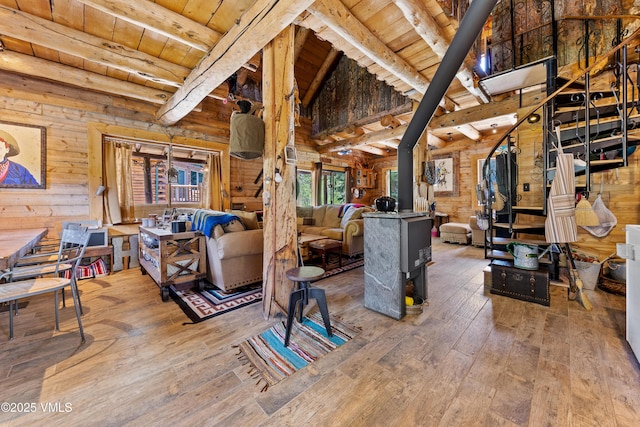 245 Main St, Eagle, CO 81631 - miscellaneous room with a wood ceiling with exposed beams, hardwood / wood-style floors, a wood stove, wood walls, and high vaulted ceiling