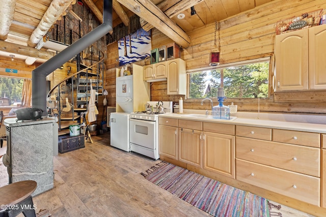 245 Main St, Eagle, CO 81631 - kitchen featuring white gas range, light brown cabinetry, wooden ceiling, healthy amount of natural light, and light wood finished floors