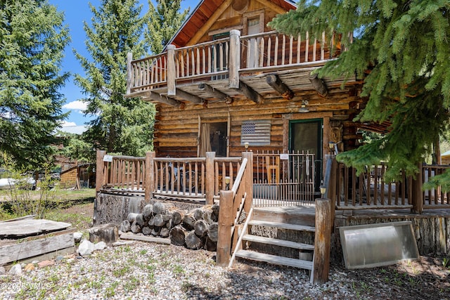 245 Main St, Eagle, CO 81631 - rear view of house with a balcony, log siding, and a deck