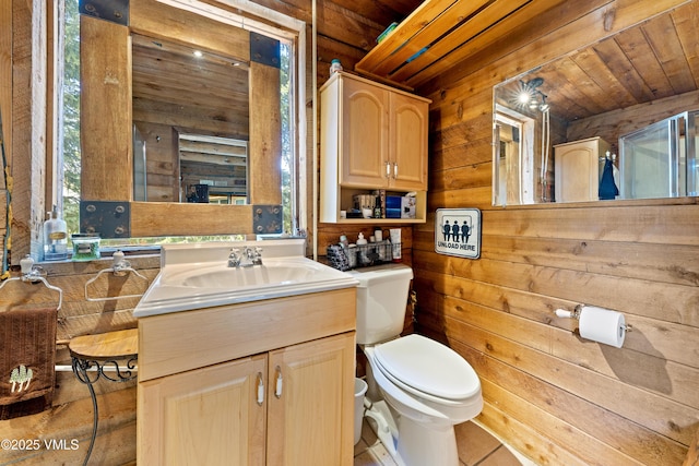 245 Main St, Eagle, CO 81631 - bathroom featuring wooden walls, vanity, wood ceiling, and tile patterned floors