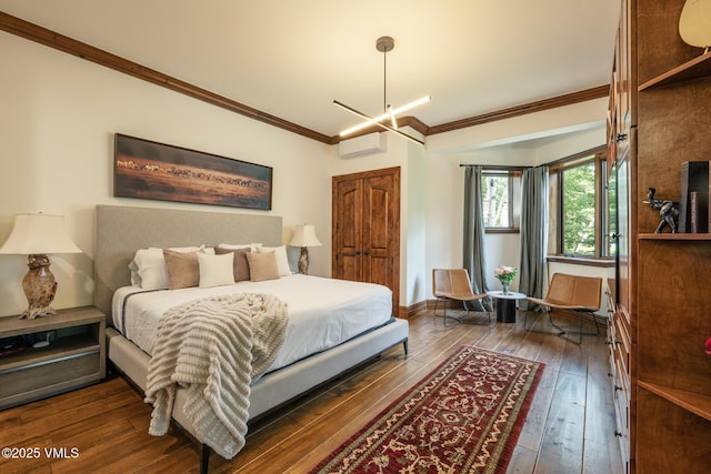 185 Forest Rd Unit A, Vail, CO 81657 - bedroom featuring a wall mounted air conditioner, crown molding, and dark wood-style flooring