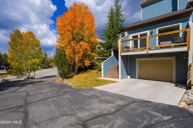 exterior space with a garage and a balcony