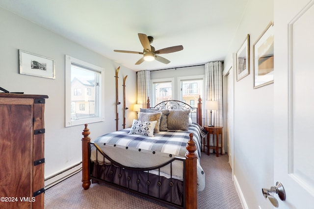 bedroom featuring a baseboard heating unit, carpet floors, and ceiling fan