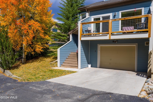 view of front of home with a balcony and a garage