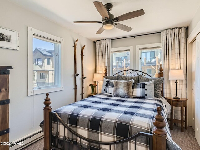 bedroom featuring multiple windows, carpet, ceiling fan, and baseboard heating