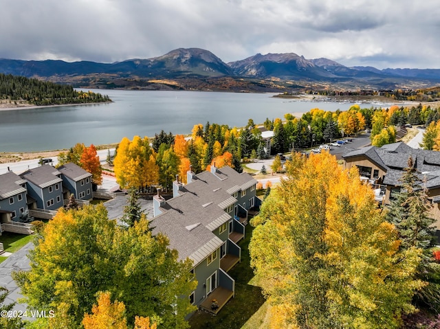 birds eye view of property with a water and mountain view