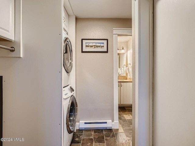 laundry room with stacked washer / dryer and a baseboard heating unit