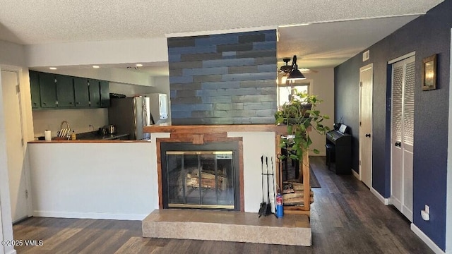 600 Price Ln Unit 6, Gypsum, CO 81637 - living room with wood finished floors, a textured ceiling, baseboards, and a glass covered fireplace