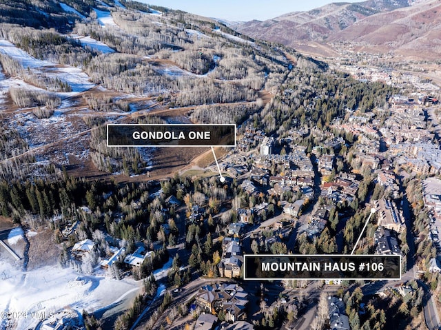 snowy aerial view with a mountain view