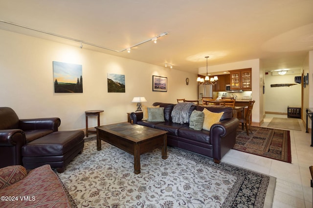 tiled living room featuring a notable chandelier