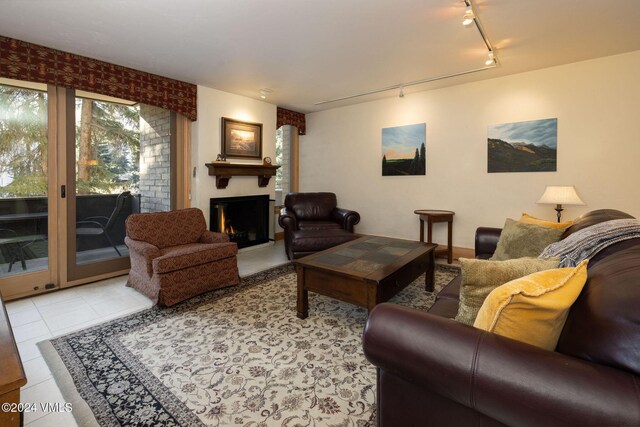 living room with light tile patterned floors and a fireplace