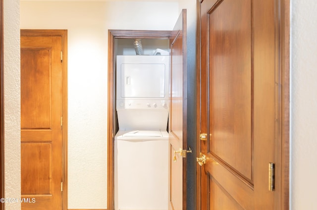 laundry room with stacked washer and clothes dryer