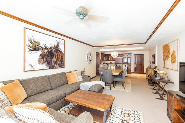 living room with crown molding and ceiling fan