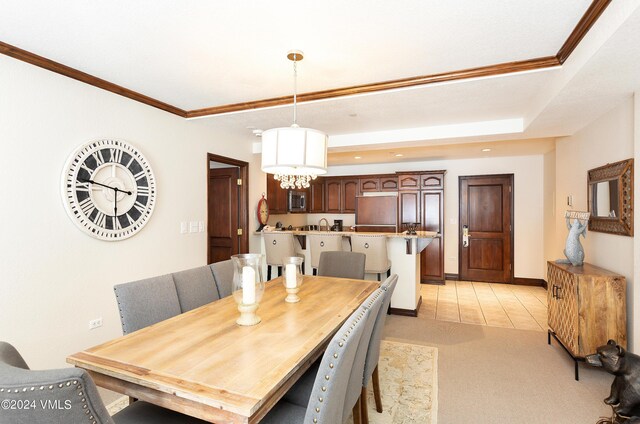 dining space featuring light carpet and crown molding