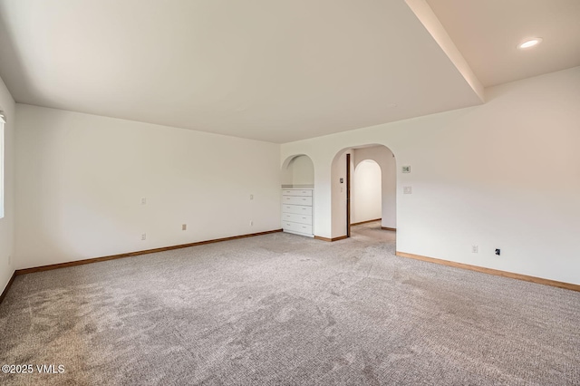 482 Charolais Cir, Edwards, CO 81632 - empty room with light colored carpet, baseboards, and arched walkways