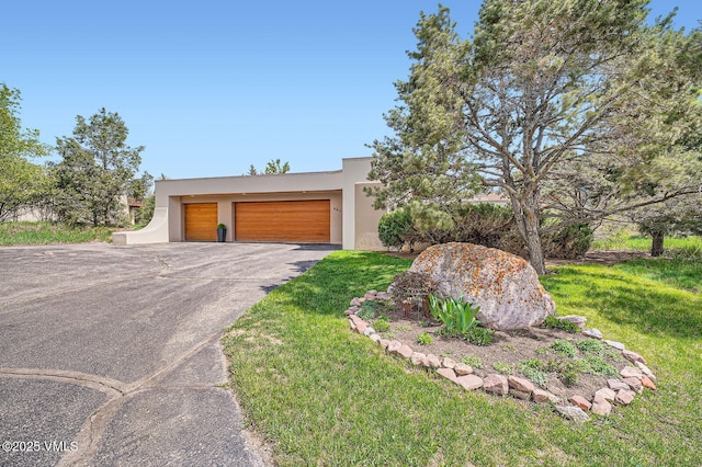 482 Charolais Cir, Edwards, CO 81632 - view of front of house with stucco siding, a front lawn, and driveway