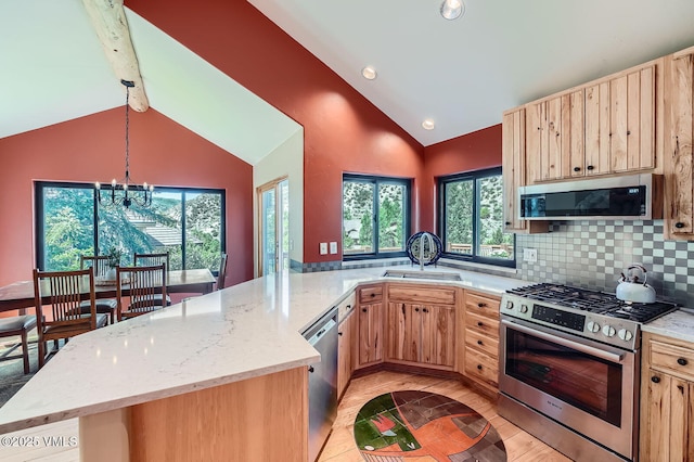 1140 June Creek Rd, Edwards, CO 81632 - kitchen featuring appliances with stainless steel finishes, light brown cabinets, a chandelier, high vaulted ceiling, and beam ceiling