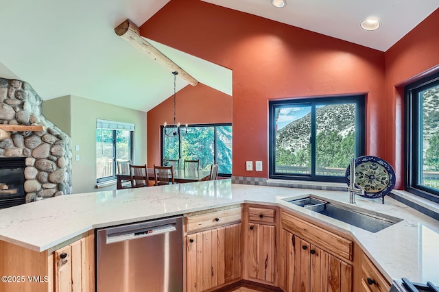 1140 June Creek Rd, Edwards, CO 81632 - kitchen with stainless steel dishwasher, light stone countertops, vaulted ceiling, a chandelier, and a fireplace