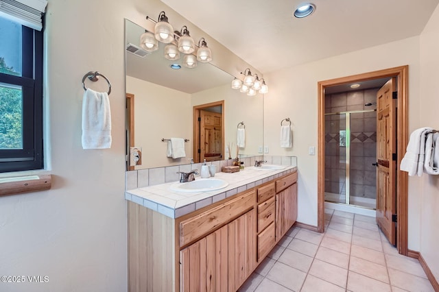 1140 June Creek Rd, Edwards, CO 81632 - full bath with double vanity, a shower stall, tile patterned flooring, and recessed lighting