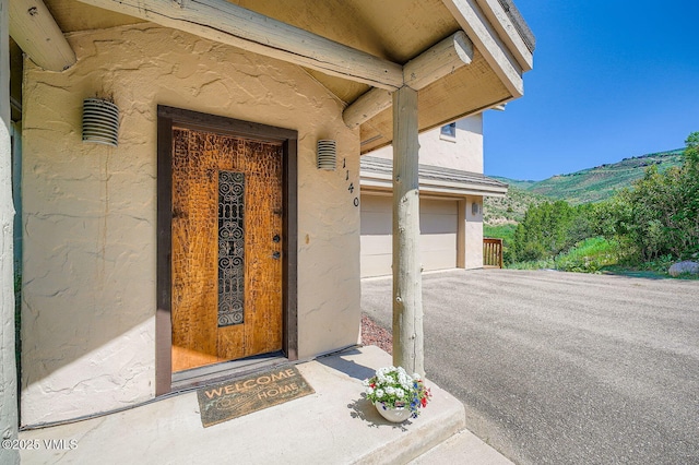 1140 June Creek Rd, Edwards, CO 81632 - doorway to property with a mountain view, driveway, and stucco siding