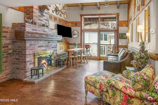 225 Wall St Unit 303, Vail, CO 81657 - living area with wood-type flooring, a brick fireplace, and beam ceiling