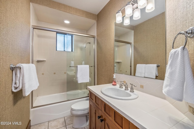 full bathroom with enclosed tub / shower combo, vanity, toilet, and tile patterned flooring