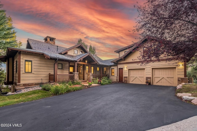 craftsman inspired home featuring a garage and covered porch