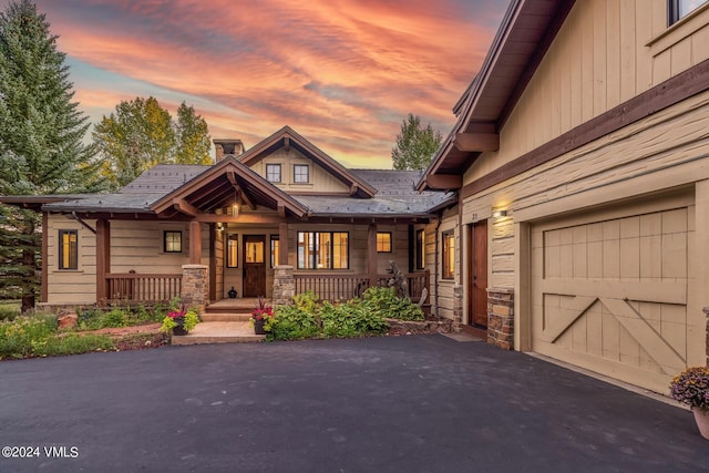 craftsman house with a garage and covered porch