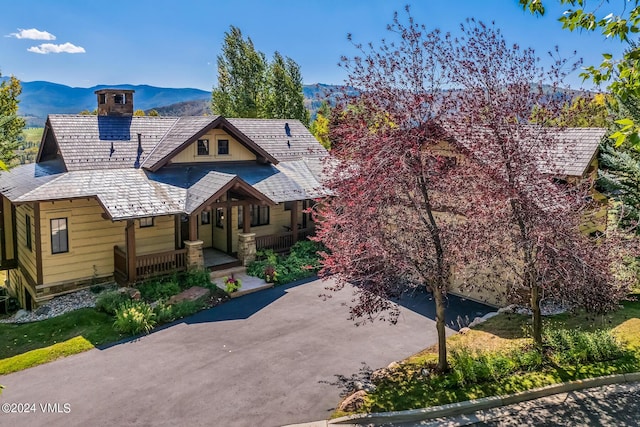 view of front of home featuring a porch and a mountain view